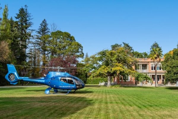 Helicopter on the lawn at Earnscleugh Castle, exclusive castle hire New Zealand in Central Otago